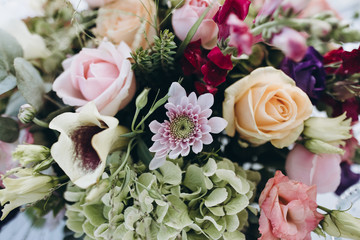 Wedding floristry. Banquet tables decorated with flower arrangements and greenery.