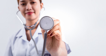 Asian female doctor holding stethoscope in hand on white background