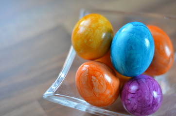 colored easter eggs in a glass bowl