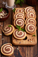 Obraz na płótnie Canvas Two colored delicious homemade cookies with vanilla and chocolate flavor in a shape of spiral. 