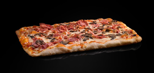 pizza with prosciutto and cheese on a black background