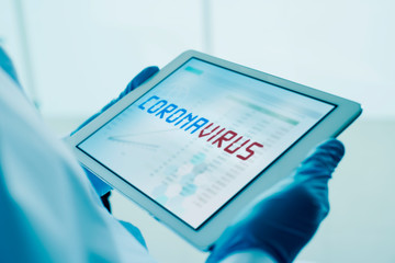doctor and the text coronavirus in a tablet