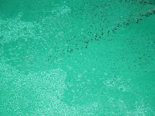Water dispersion on a green background.