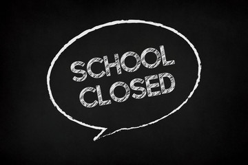 School closed writing in speech bubble on chalkboard