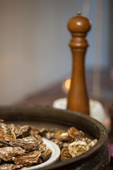 Healthy sea food, fresh Oysters with pepper gourmet close-up on white and black plate served in a restaurant