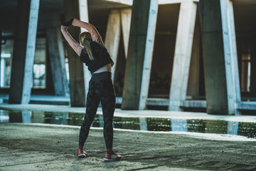 Fototapeta na wymiar Young Caucasian woman doing side stretch exercises