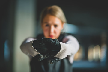 Close-up of a young Caucasian women with arms stretched out, fingers crossed