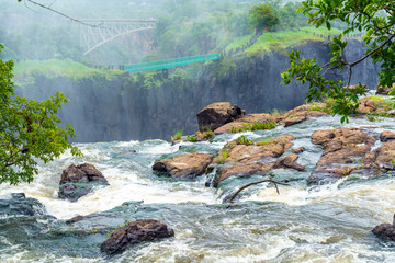Panorama view with waterfalls and bridge at  Victoria Falls on the Zambezi River, Zimbabwe, Zambia.
