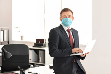 Male lawyer in protective mask working in office