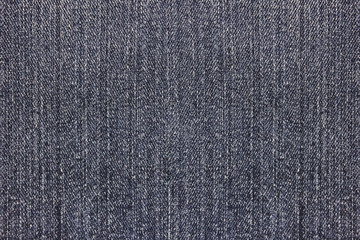 Fototapeta na wymiar Dark gray denim jeans texture background. Grainy abstract grey jeans, empty modern denim pants background. Blank jean material pattern, close up top view
