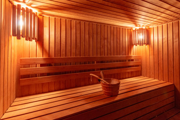 Fototapeta na wymiar sauna bathhouse warm interior inside empty brooms barrels bucket for water