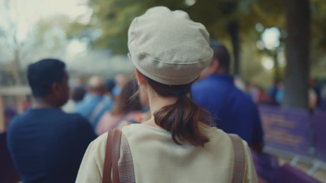 Young girl standing in the queue at the Eiffel Tower