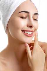 Girl with towel on head on white background,with clear skin