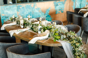 banquet table is decorated with plates, cutlery, glasses, candles and flower arrangements