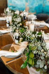 banquet table is decorated with plates, cutlery, glasses, candles and flower arrangements