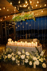 banquet table is decorated with plates, cutlery, glasses, candles and flower arrangements