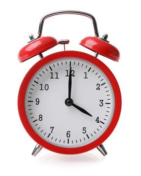 Red alarm clock set at four isolated over white background