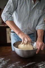 Fototapeta premium male hands making bread in kitchen at home