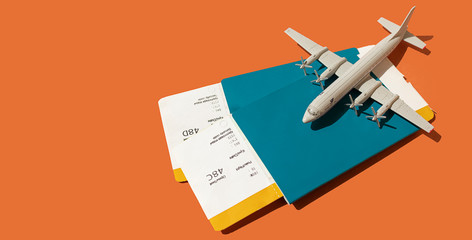 toy plane on the background of passports with tickets, the concept of resuming flights around the...