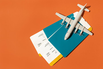 toy plane on the background of passports with tickets, the concept of resuming flights around the world after the coronavirus, financial losses of airlines and tour operators.