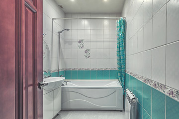 Small beige tile bathroom with bath tube