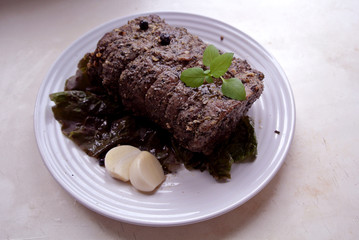 Beef and beef meat in a glass plate. Roast beef in spices. Cooking meat marinating in spices and herbs