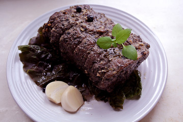 Beef and beef meat in a glass plate. Roast beef in spices. Cooking meat marinating in spices and herbs