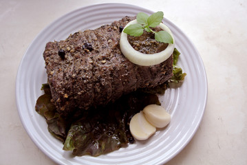 Beef and beef meat in a glass plate. Roast beef in spices. Cooking meat marinating in spices and herbs