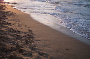 Sea waves coming to a sandy beach
