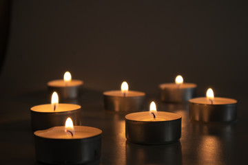 Fototapeta na wymiar Religious burning candles: for praying times for christians, catholics, jewish, buddhist