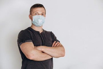 Protection against contagious disease, coronavirus. The man of European appearance wearing hygienic mask to prevent infection, airborne respiratory illness such as flu, 2019-nCoV, on white background.