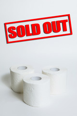 A supply of several rolls of toilet paper in case of an epidemic. Sold out text.  COVID-19 coronavirus outbreak concept. Shortage due to buying panic. White background, copy space