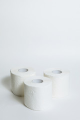 A supply of several rolls of toilet paper in case of an epidemic. COVID-19 coronavirus outbreak concept. Shortage due to buying panic. White background, copy space