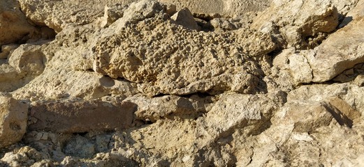 small stones in the center of the old city. The gray cobblestones are laid out in order, like road tiles. Natural gray and brown tones of stone at sunset