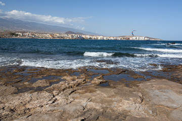 Panoramic view at the volcanic beach and the resort embankment in the bohemian village of El Medano, Tenerife, Canary Islands, Spain.