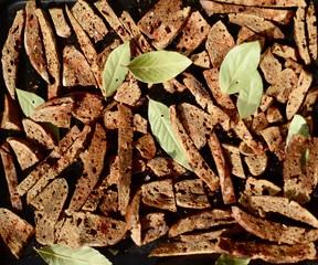  Background from croutons. Rye croutons with spices and bay leaves. Organic food. Vegetarianism.