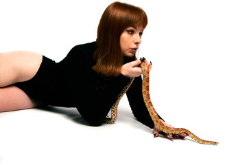 Beautiful woman in black bodywear and snake. Ginger model girl with fashion perfect make up.