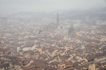 Fototapeta na wymiar view of the basilica of Santa Croce from the dome of the Florence Cathedral on a foggy day