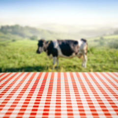 Table background of free space and cow with natural landscape 