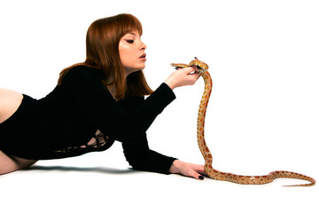Beautiful woman in black bodywear and snake. Ginger model girl with fashion perfect make up.