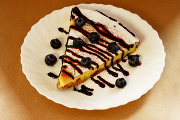 Appetizing curd casserole with blueberries side view.