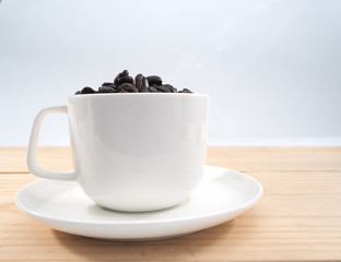 Coffee bean in a cup of coffee isolate on white background.Have copy space.for banner,wallpaper.