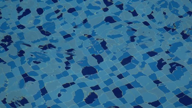 Patterns and ripples of swimming pool blue water surface background.