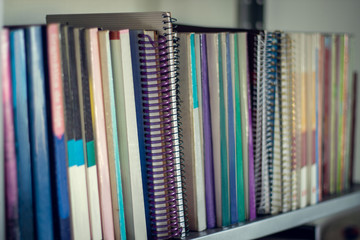 Collection of educational books on a bookshelf
