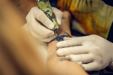 Girl getting tattoo on her arm
