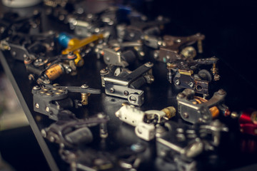 Collection of old tattoo guns in a tattoo studio.