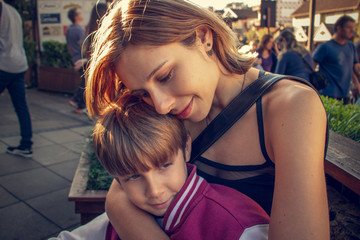 Mother and son posing for photo in the city.