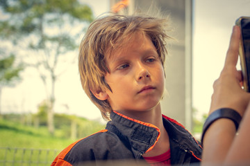 Portrait of a boy after taking his helmet off from a race.