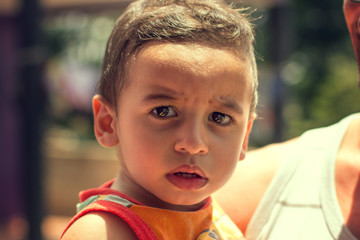 Cute little child looking suspicious for photo.