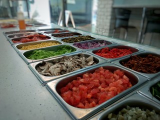 A pizzeria in the city with various ingredients